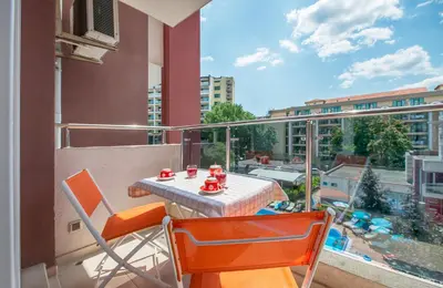 a table and chairs on a balcony with a view at Admiral Plaza Holiday Apartments in Sunny Beach