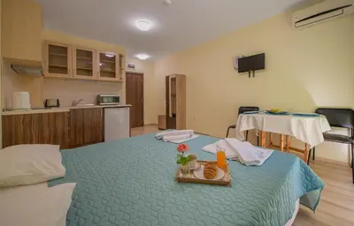 a room with a bed with a tray of food on it at Admiral Plaza Holiday Apartments in Sunny Beach