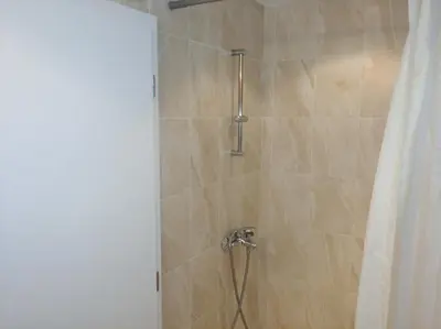 a bathroom with a shower with a shower curtain at Niya Apartments Kavaci Sozopol in Sozopol