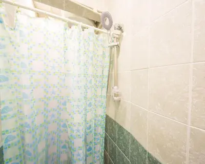 a shower with a shower curtain in a bathroom at DOWNTOWN - BEST Price Small Apartment in Burgas City