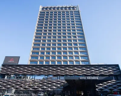 a tall building with a sign in front of it at DOWNTOWN - BEST Price Small Apartment in Burgas City