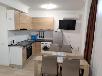 a kitchen with a table and chairs in a room at Apartments Sarafovo in Burgas City