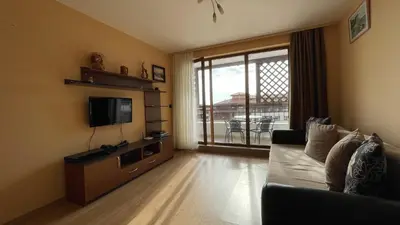 a living room with a couch and a flat screen tv at GARDEN OF EDEN B3-2 Private One Bedroom Apartment in Sveti Vlas