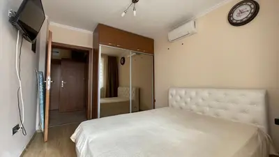 a bedroom with a bed and a clock on the wall at GARDEN OF EDEN B3-2 Private One Bedroom Apartment in Sveti Vlas
