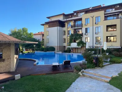 a swimming pool with two chairs next to a building at GARDEN OF EDEN B3-2 Private One Bedroom Apartment in Sveti Vlas