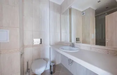 a bathroom with a toilet and a sink at Stoyanov South Bay - Varna in Varna City