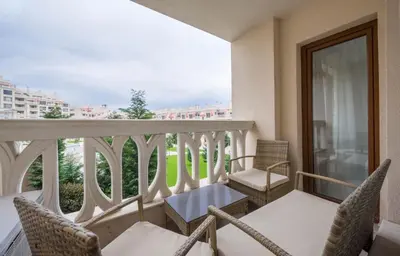 a balcony with chairs and a table at Stoyanov South Bay - Varna in Varna City