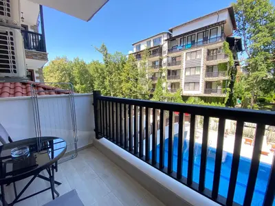 a balcony with a view of a swimming pool at The Green Paradise Apartments in Primorsko