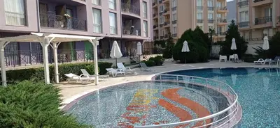 a swimming pool in front of a building at RAINBOW 3-103 Cozy Studio Sunny Beach in Sunny Beach