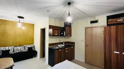a room with a kitchen and a couch in it at RAINBOW 3-103 Cozy Studio Sunny Beach in Sunny Beach