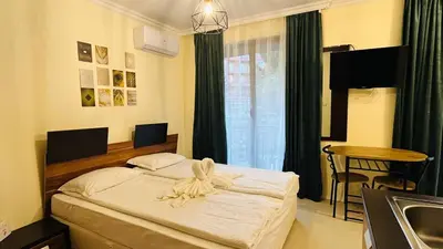 a bedroom with a bed with a towel on it at RAINBOW 3-103 Cozy Studio Sunny Beach in Sunny Beach