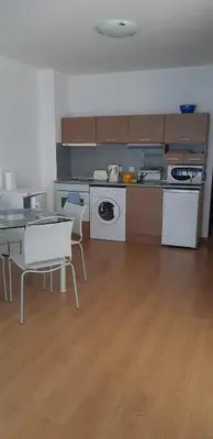 a kitchen with a table and a table and chairs at Excelsior Holiday Apartments 91 Sunny Beach Bulgarien Sonnenstrand in Sunny Beach