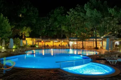 a large blue swimming pool at night at Excelsior Holiday Apartments 91 Sunny Beach Bulgarien Sonnenstrand in Sunny Beach