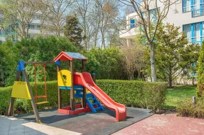 a playground with a slide in a park at Excelsior Holiday Apartments 91 Sunny Beach Bulgarien Sonnenstrand in Sunny Beach