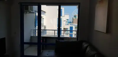a living room with a view of a balcony at Excelsior Holiday Apartments 91 Sunny Beach Bulgarien Sonnenstrand in Sunny Beach