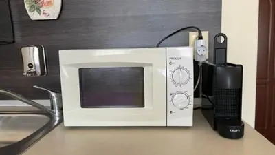 a microwave sitting on top of a counter at SUMMER BREEZE 406 Studio Sunny Beach in Sunny Beach