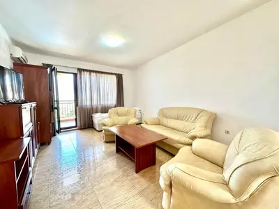 a living room with two couches and a table at Аpartments Comfort -Marina Cape in Aheloy
