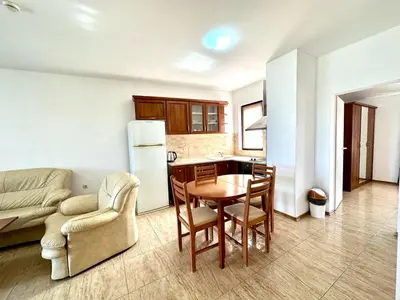a living room with a table and a kitchen at Аpartments Comfort -Marina Cape in Aheloy