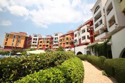 a walkway next to a row of apartment buildings at Аpartments Comfort -Marina Cape in Aheloy