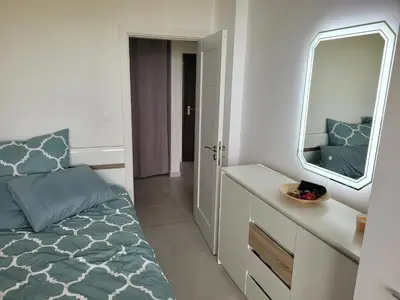 a small bedroom with a bed and a mirror at Bayview B32 - Burgas Beach Resort 2 in Burgas City