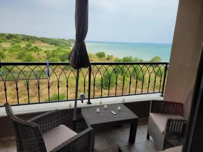 a balcony with a table and chairs and a view at Bayview B32 - Burgas Beach Resort 2 in Burgas City