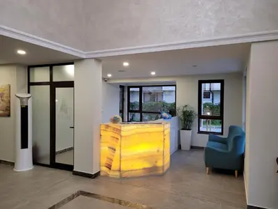 a lobby with a yellow cabinet and a blue chair at Bayview B32 - Burgas Beach Resort 2 in Burgas City