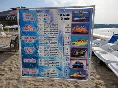a sign on the beach with a price list at Bayview B32 - Burgas Beach Resort 2 in Burgas City