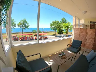 a room with a large window with a view of a trolley at Sunset Yavorov Pomorie in Pomorie