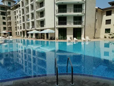 a large swimming pool in front of a building at Lovely Apartments Amadeus Lux in Sunny Beach