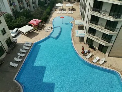 an overhead view of a large swimming pool between two buildings at Lovely Apartments Amadeus Lux in Sunny Beach