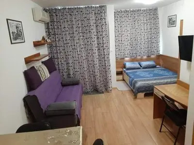 a small room with a bed and a couch at Apartment Jasna Hotel Oazis in Ravda