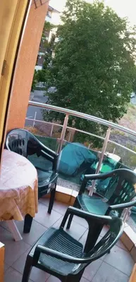 two chairs and a table on a balcony at Apartment Jasna Hotel Oazis in Ravda