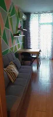 a living room with a couch and a table at Apartment Jasna Hotel Oazis in Ravda