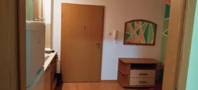 a kitchen with a door and a table and a mirror at Apartment Jasna Hotel Oazis in Ravda