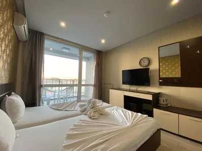 a hotel room with a bed and a large window at PARADISO B 210 Private Sea View Studio NESSEBAR in Nesebar