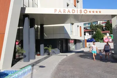 two women and a child walking in front of a building at PARADISO B 210 Private Sea View Studio NESSEBAR in Nesebar