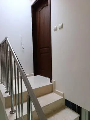 a set of stairs with a wooden door at Family Hotel Lalov Egrek in Lozenets