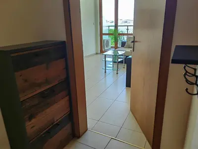a hallway with a door and a tile floor at Beachfront Apartments by Marty's in Sunny Beach