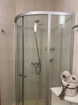 a shower in a bathroom with a glass door at Rutland SP apartments in Ravda