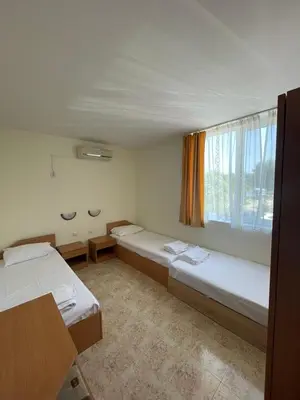 a room with two beds and a window at Rutland SP apartments in Ravda