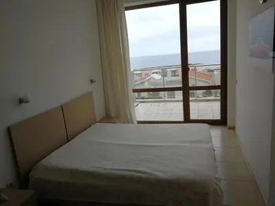 a bedroom with a bed and a large window at Fantastic family villa with sea view in Byala