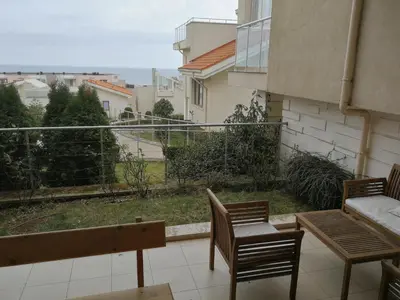 a balcony with two chairs and a view of a street at Fantastic family villa with sea view in Byala