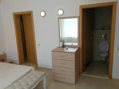 a bedroom with a bed and a bathroom with a toilet at Fantastic family villa with sea view in Byala