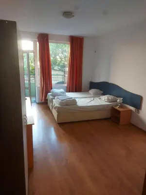 a bedroom with a bed and a window at Studio and 1bedroom apartment Burgas - Economy in Burgas City