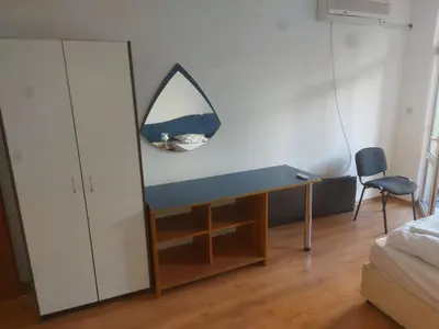 a desk in a bedroom with a mirror on the wall at Studio and 1bedroom apartment Burgas - Economy in Burgas City