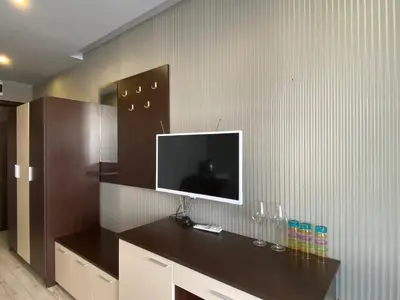 a living room with a tv on a wall at PARADISO B 209 Private Sea View Studio NESSEBAR in Nesebar