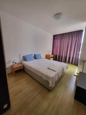 a bedroom with a large bed and a window at Oazis Ravda in Ravda