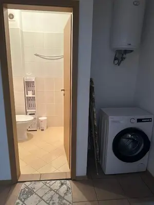 a bathroom with a washing machine and a toilet at Oazis Ravda in Ravda