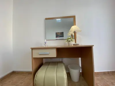 a desk with a mirror and a lamp on it at ANITA A 25 Apartment Pool View SUNNY BEACH in Sunny Beach