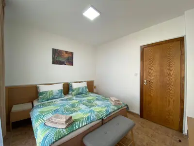 a small bedroom with a bed and a chair at ANITA A 25 Apartment Pool View SUNNY BEACH in Sunny Beach